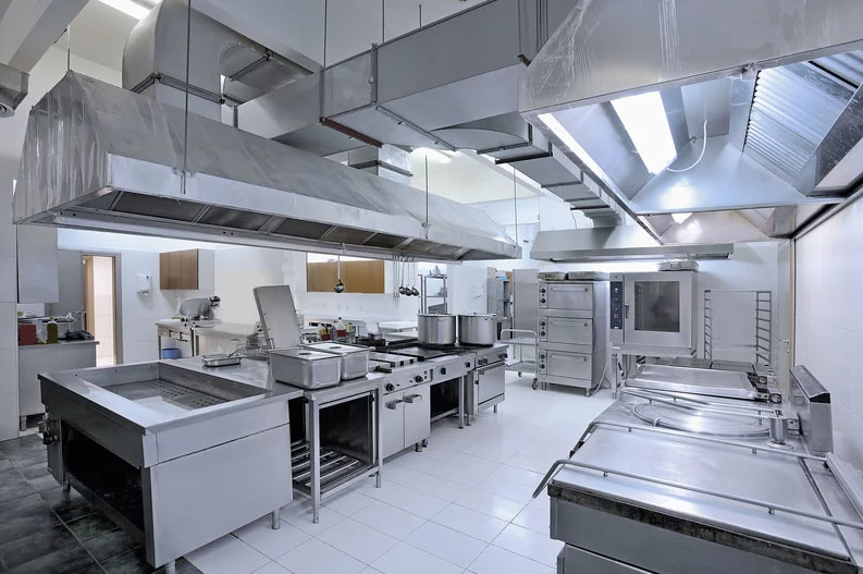 Commercial kitchen in Sydney with stainless steel cooking equipment and exhaust canopies